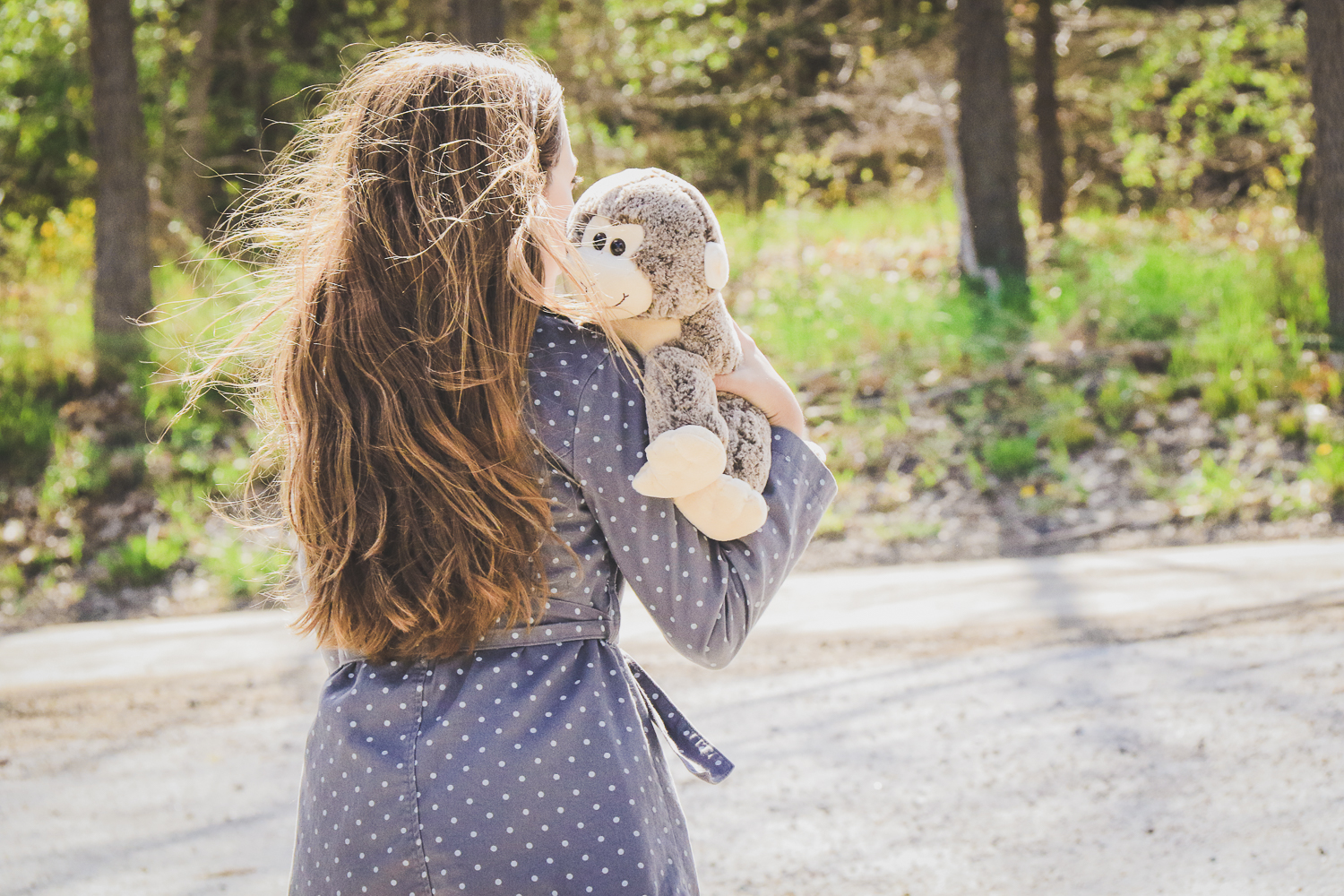 A child holding a plush monkey buddy